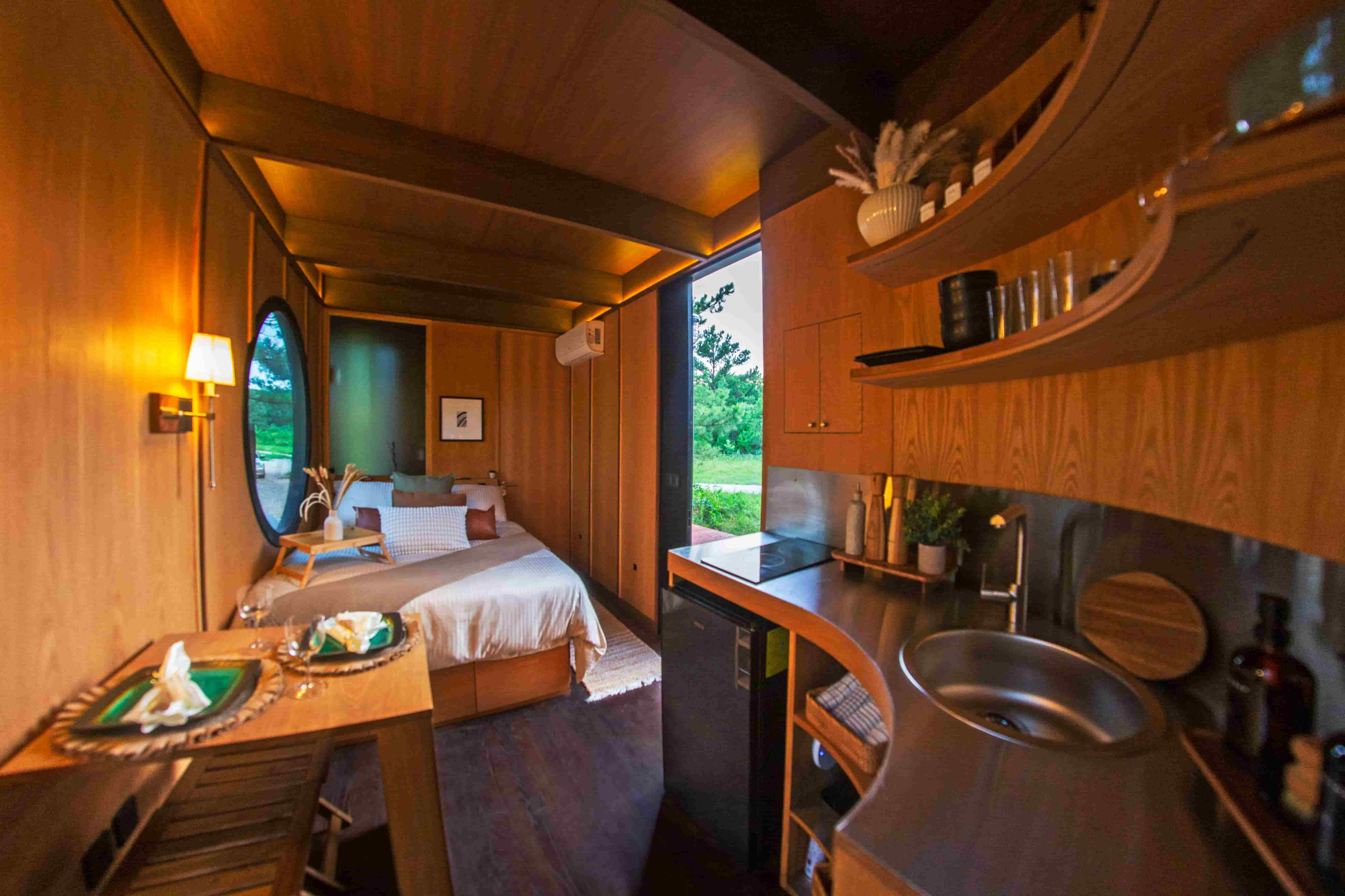Integrated kitchen and sleeping space at Cabin SOL